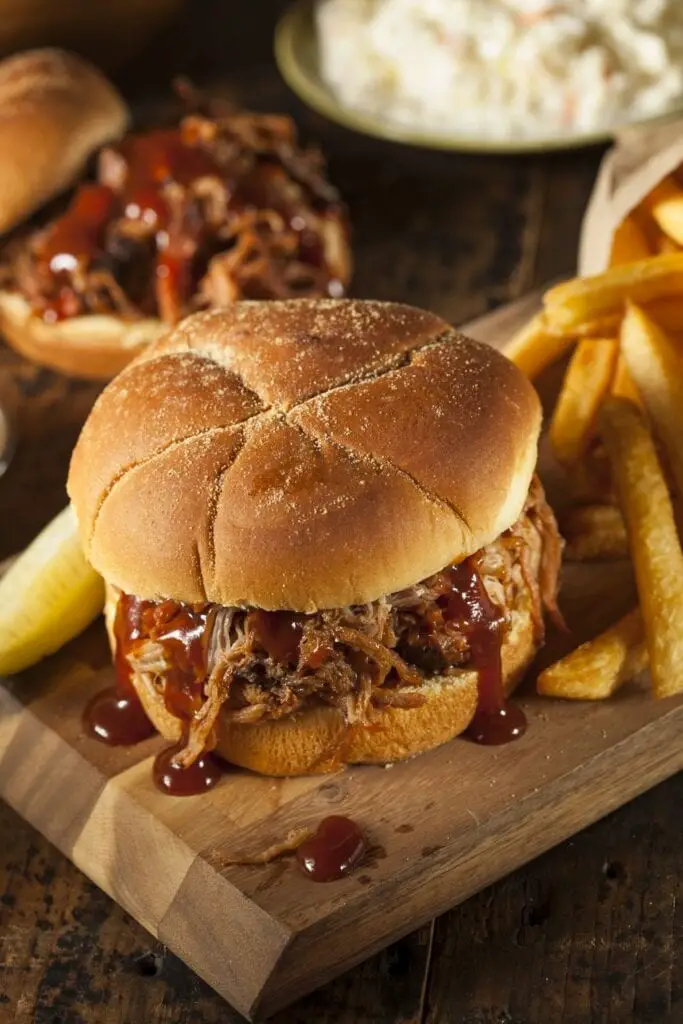 35 Easy Slow Cooker Pork Recipes You'll Love With A Homemade Pulled Pork Sandwich With French Fries