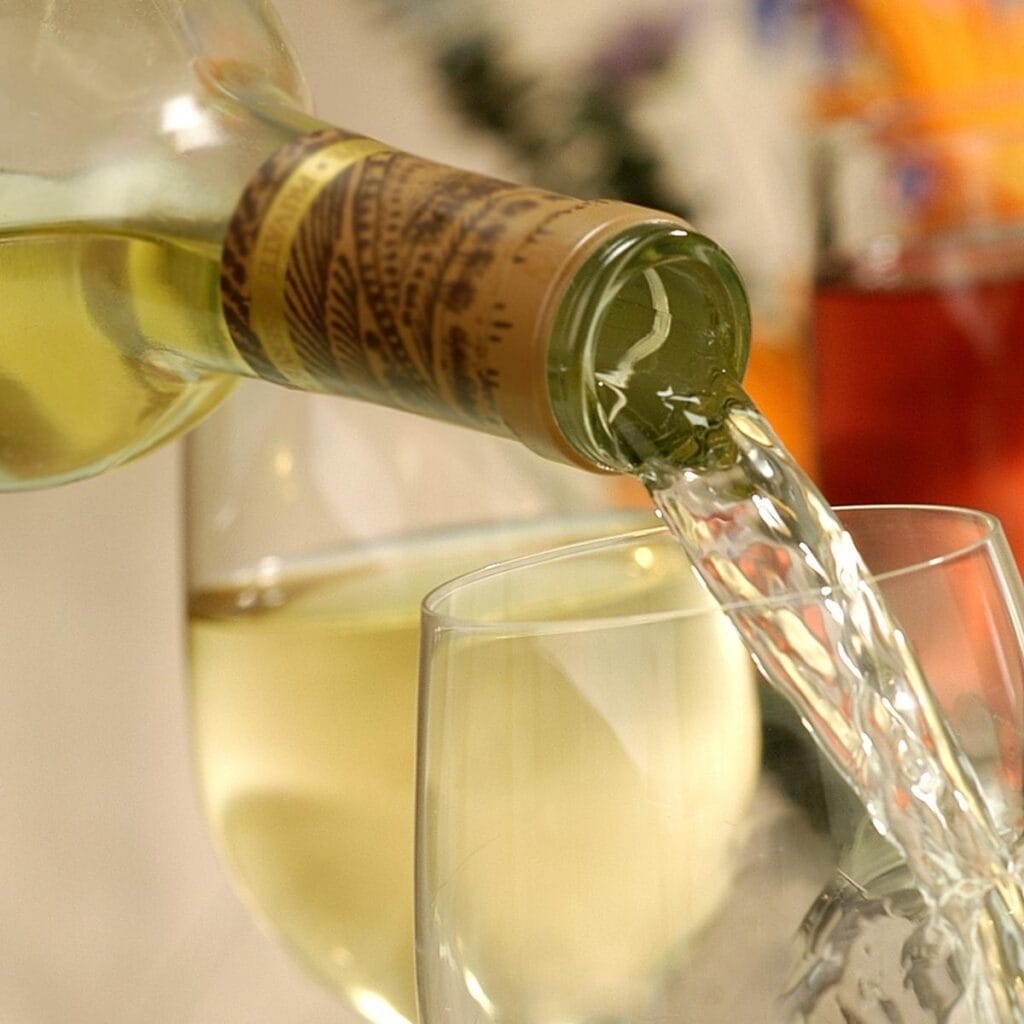 Hvidvin hældes i et glas