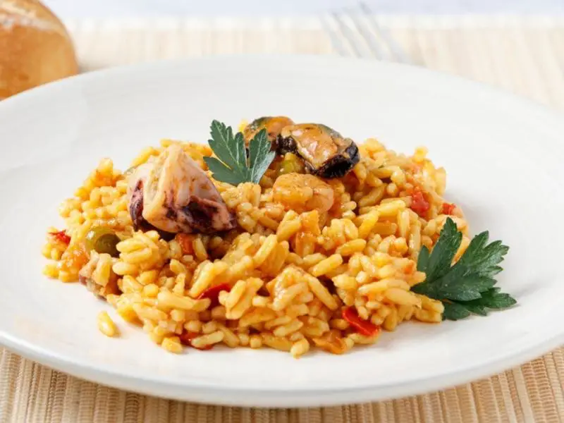 Paella in white plate of Valencian rice