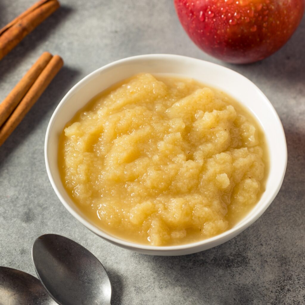 Apple sauce in a white bowl with cinnamon