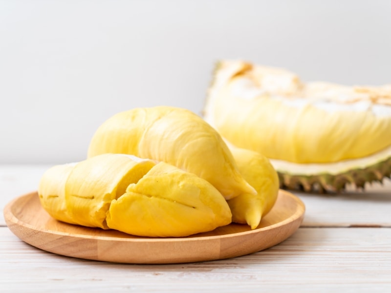 Carne de durián en un plato de madera