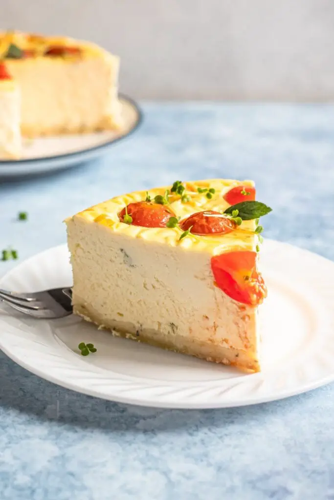 Slice of savory cheesecake with tomato and mint