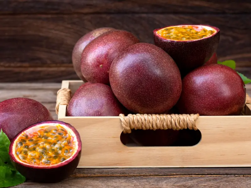 Fresh passion fruits on wooden tray