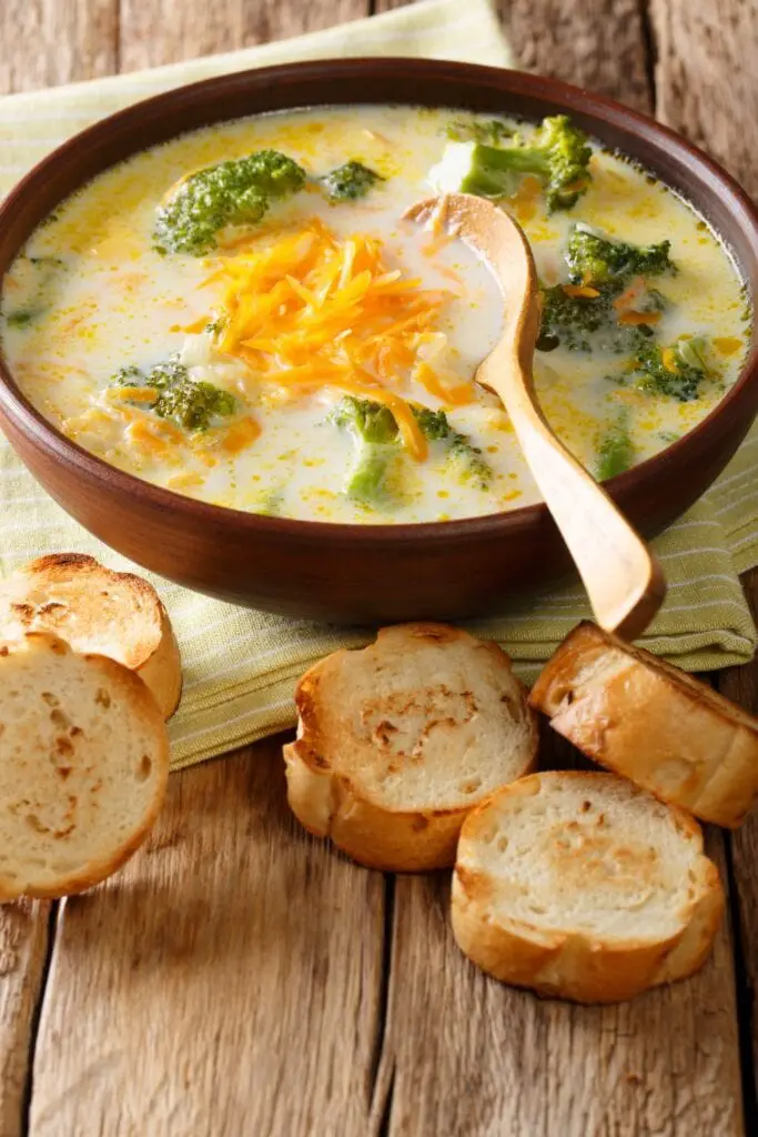 Broccoli and cheese soup in a bowl with bread